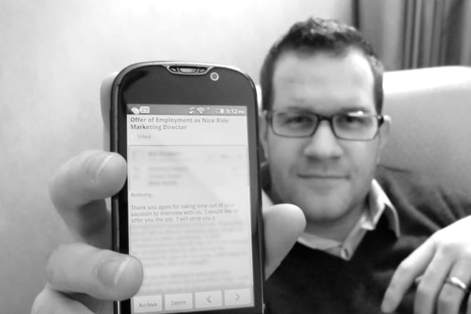 Holding Up Phone To Show Job Offer